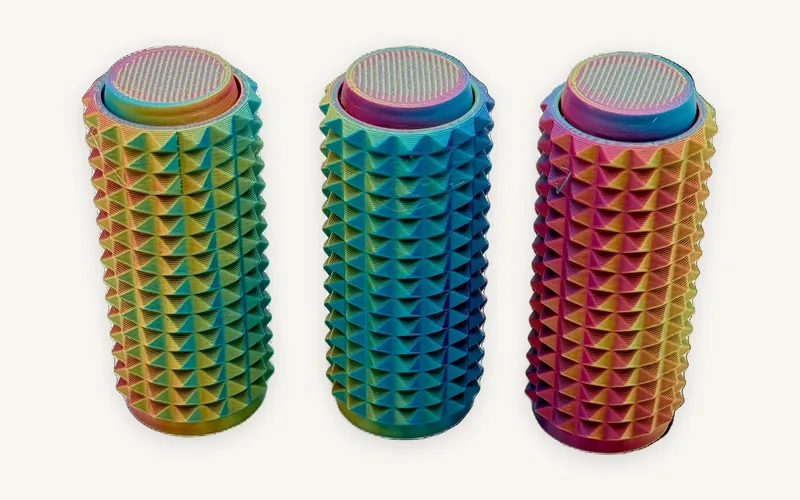 Three spiky 3D-printed fidget clickers in rainbow multicolour filament